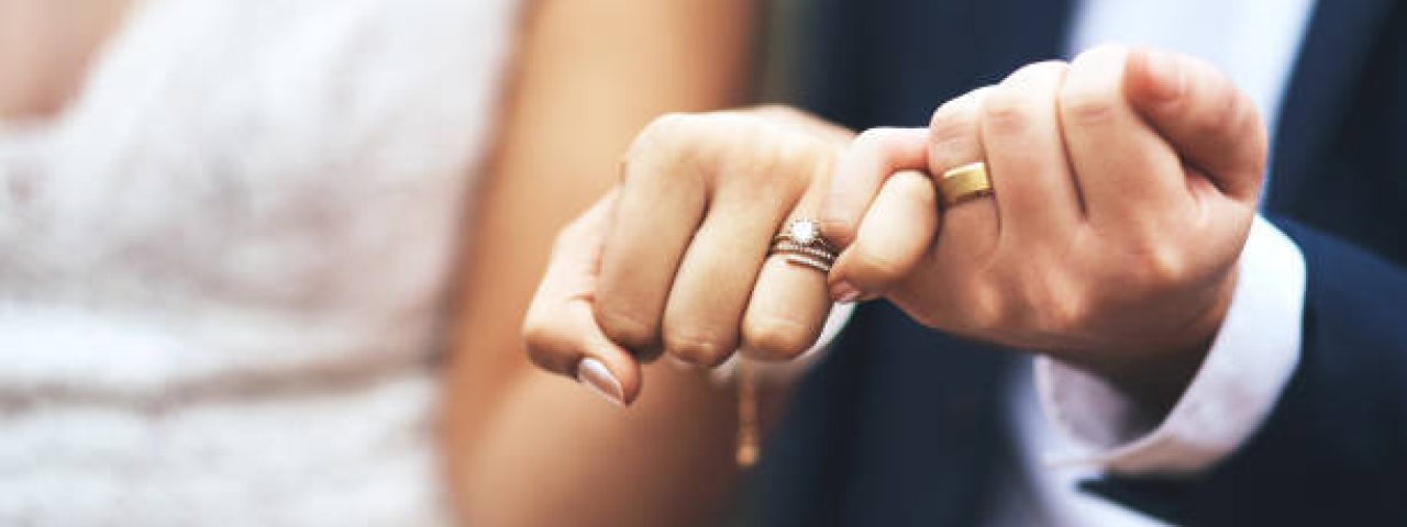 Cropped shot of an unrecognizable newlywed couple doing a pinky swear gesture on their wedding day